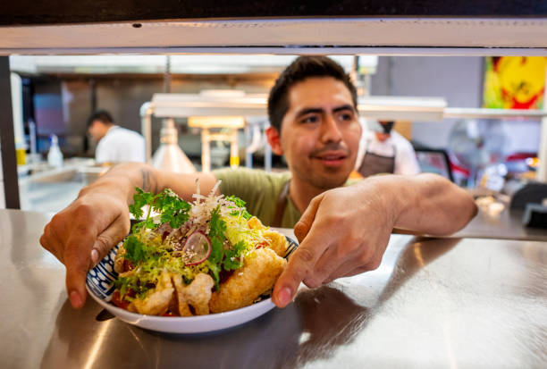 istock Mexican chef with food orders in an authentic Mexican restaurant 1018355686