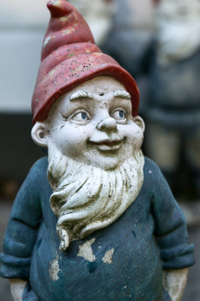 istock Garden gnome with blue shirt and red cap 1018358452