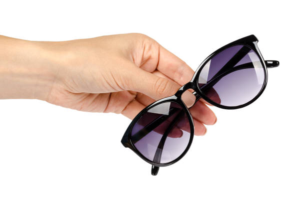 istock Stylish plastic sunglasses with hand isolated on white background 1018358854