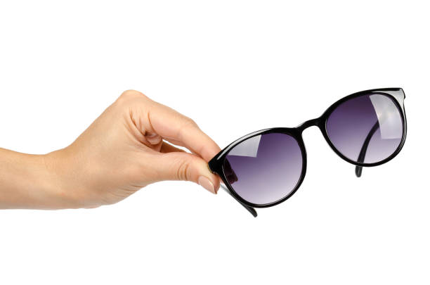 istock Stylish plastic sunglasses with hand isolated on white background 1018358862