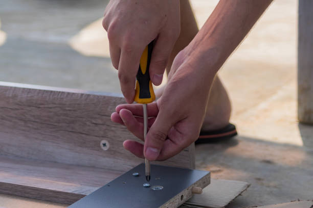 istock furniture assembling - Carpentry screws for a knock down wooden table. 1018359546
