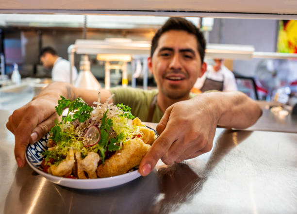 istock Mexican chef with food orders in an authentic Mexican restaurant 1018359548