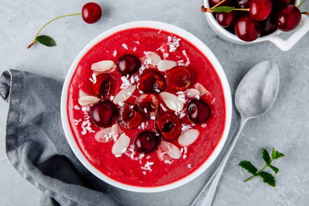 istock Red cherry smoothie with fresh berries, almond flakes and coconut chips. 1018365034