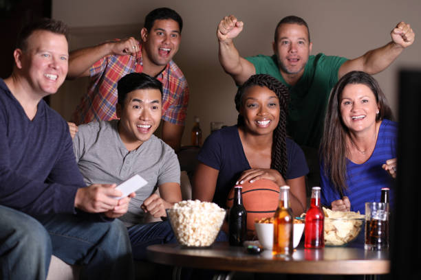 istock Basketball fans watching the game at home on television. 1018374992