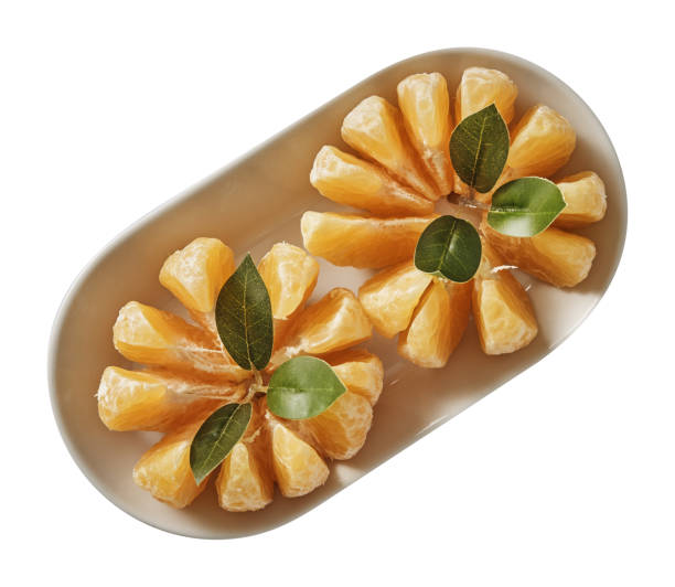 Tangerine on plate. Preparing ingredients for cooking. Isolated on white background. Top view.