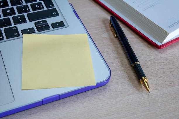 istock Laptop computere on a white clear desk with sharp pencils and stick notes book 1018378628