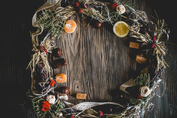 istock Creative Christmas wreath with sweets. An unusual idea for a holiday home decor. Natural interior decor on wooden background. 1018383668