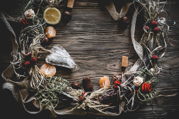 istock Creative Christmas wreath with sweets. An unusual idea for a holiday home decor. Natural interior decor on wooden background. 1018383800