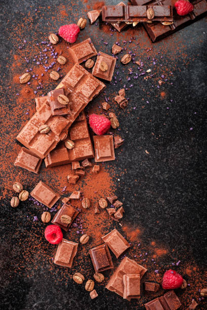 istock Broken chocolate pieces and cocoa powder on marble. 1018389644