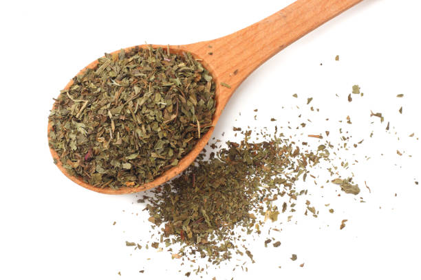 istock dried mint in wooden spoon isolated on white background 1018397774