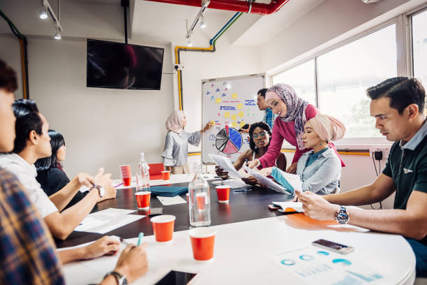 istock Teamwork in new company with multi-ethnic employees 1018401066