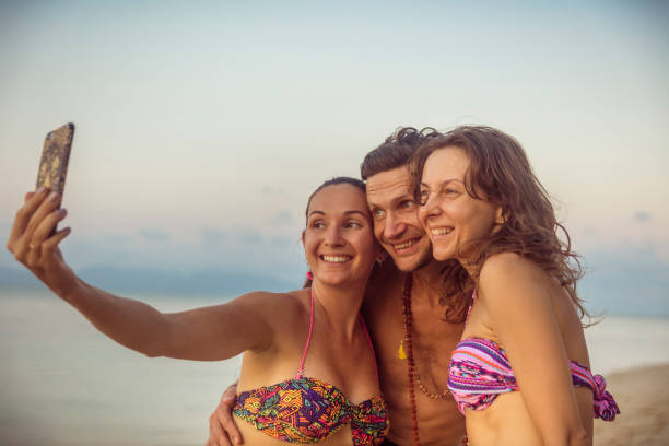 istock Friends doing selfie photo on the beach 1018404096