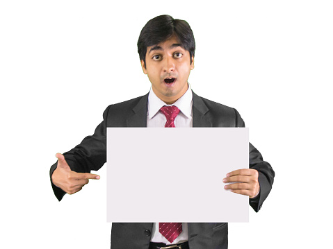 Young business man showing blank placard in shock expression, isolated on white background.