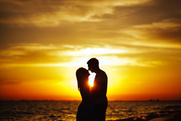 istock Young happy couple on seashore. 1018404586