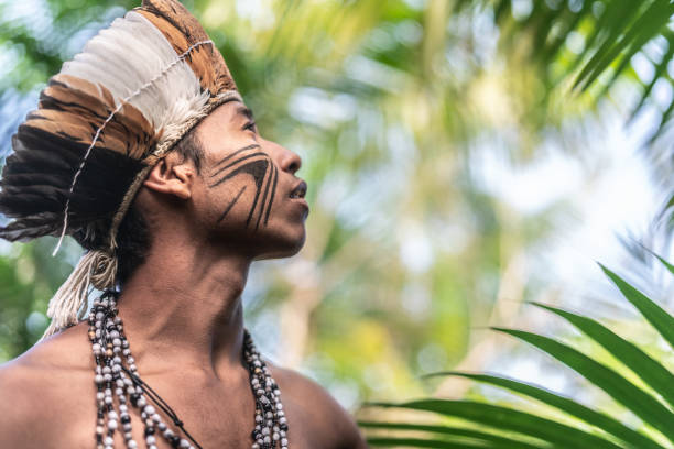 Indigenous Brazilian Young Man Portrait from Guarani Ethnicity Beautiful shooting of how Brazilian Native lives in Brazil Sustainable Lifestyle indigenous culture stock pictures, royalty-free photos & images