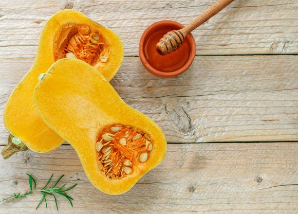 istock Raw organic butternut squash with ingredients for cooking on a wooden table. Selective focus 1018410484
