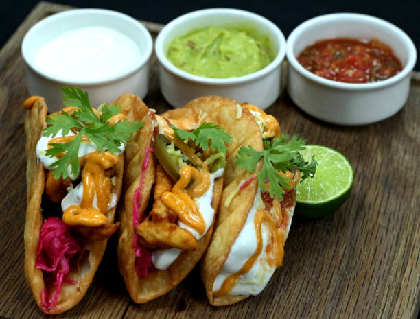 istock Mexican tacos on wood board 1018416778
