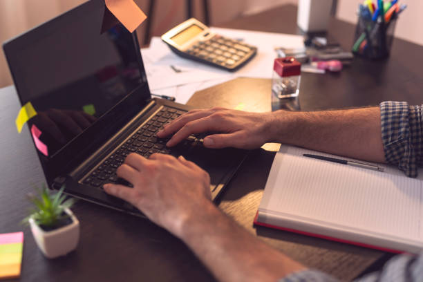 istock Businessman typing on a laptop computer keyboard 1018424622