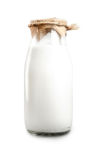 A bottle of fresh milk isolated on a white background closeup