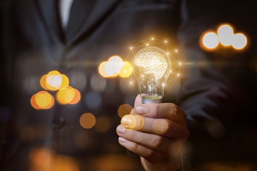 Light bulb with brain the hands of the businessman. The concept of the business idea.