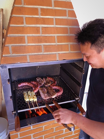 Taken by iphone X. Japanese man making barbecue.
