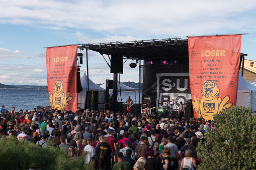 Seattle, USA - Aug 11, 2018: A Crowd watching the band Fastbacks at the SPF30 SUB POP party on the Beach in West Seattle late in the day.