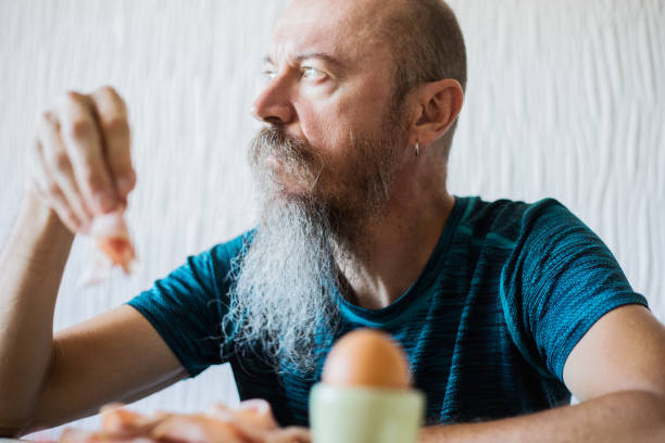 istock Middle aged man having breakfast, real people 1018442346