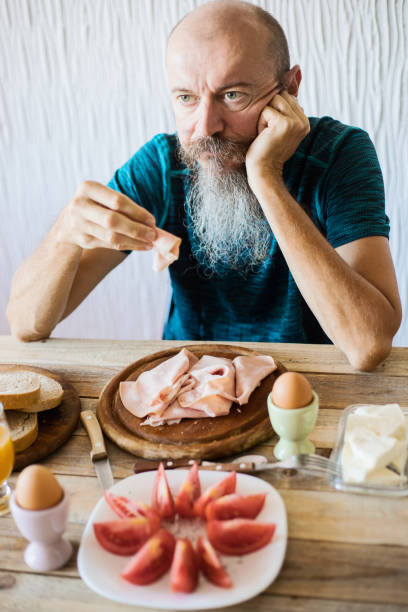 istock Middle aged man having breakfast, real people 1018443120