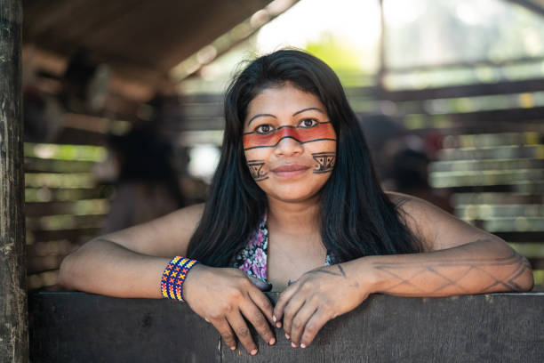 Indigenous Brazilian Young Woman, Portrait from Guarani Ethnicity, in a Hut Beautiful shooting of how Brazilian Natives lives in Brazil meet in the middle concept stock pictures, royalty-free photos & images