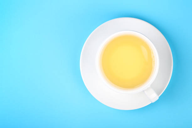 istock White cup of green oolong tea over blue 1018445534