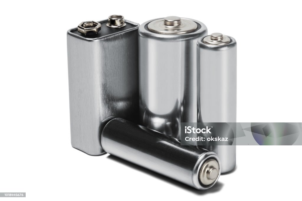 Three batteries AAA, AA and PP3 on white isolated background. Concept of renewable energy and sources of electrical power. Pattern for designer of environmental power sources, electrical power sources. Alcoholics Anonymous Stock Photo