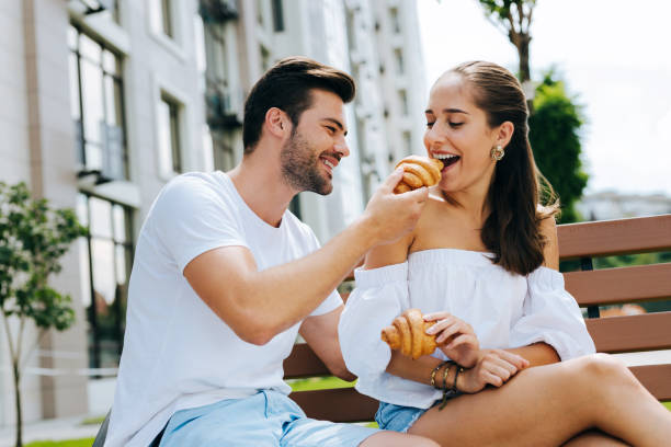 istock Positive young woman trying a croissant 1018451054
