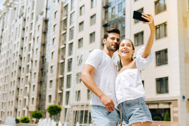 istock Joyful happy couple taking selfies 1018455496