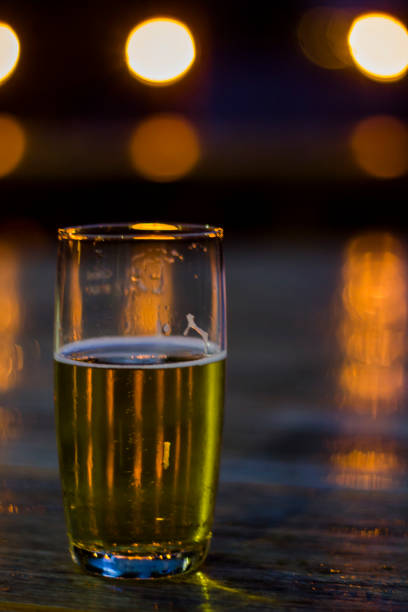 istock Glass of beer with blurred lights on background 1018458638