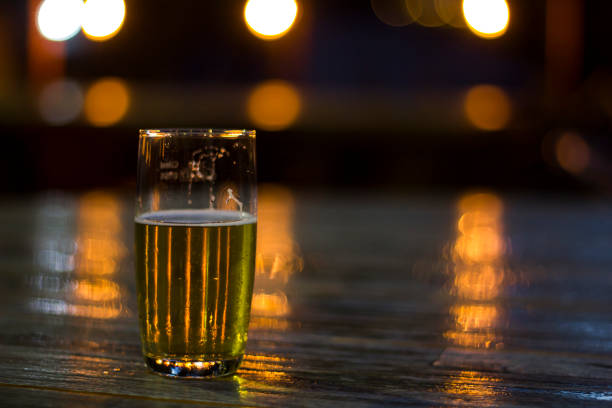 istock Glass of beer with blurred lights on background 1018458648