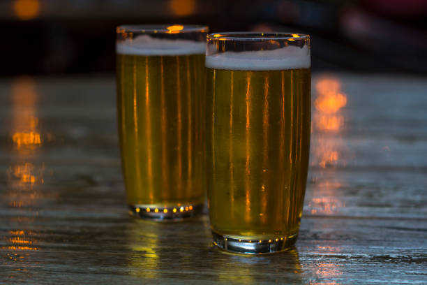 istock Glasses of beer with blurred lights on background 1018458696