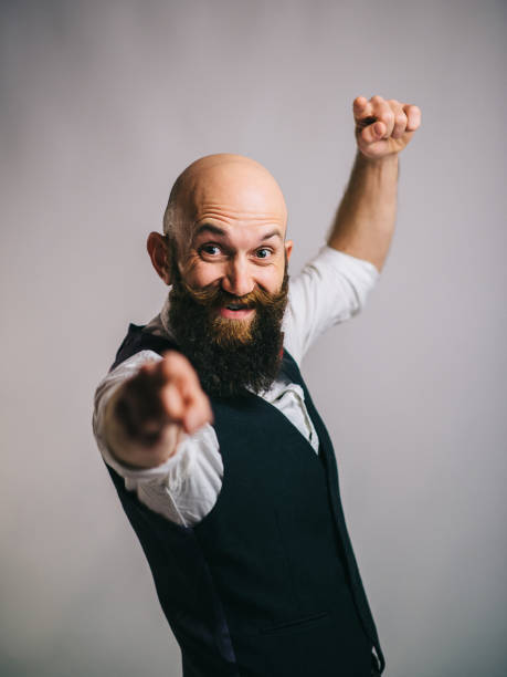 istock bearded man smiling and gesturing with his hands 1018472264