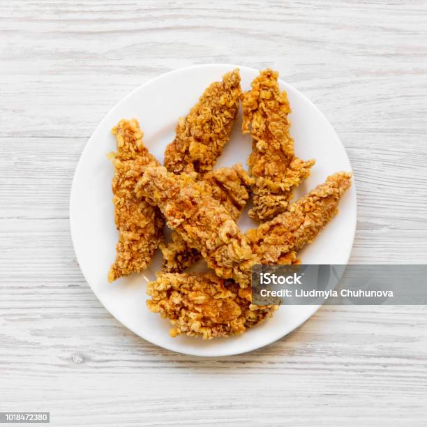 Spicy Chicken Strips On White Plate Over White Wooden Background Top View Flat Lay From Above Overhead Stock Photo - Download Image Now