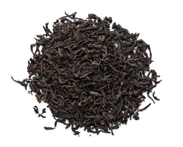 istock Dried black tea leaves isolated on white background. Top view. 1018475300