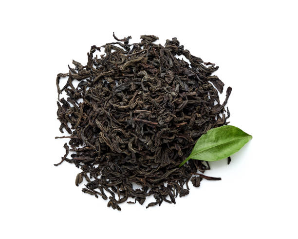 istock Dried black tea leaves isolated on white background. Top view. 1018477350