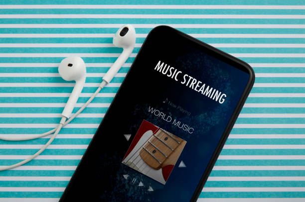 Online music streaming on smartphone with earphones stock photo