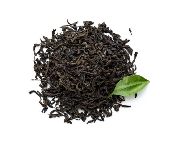 istock Dried black tea leaves isolated on white background. Top view. 1018482390