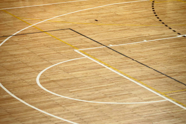 Lines of wooden floor basketball court in the sports hall.