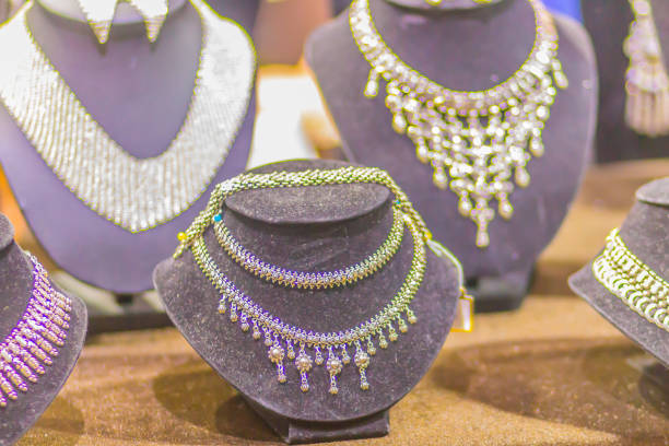 istock Beautiful silver necklaces in the luxury retail store window display showcase. 1018495876