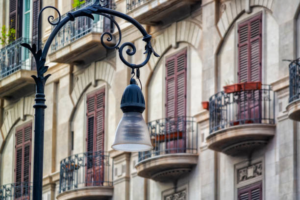 Photo of an old italian building with many balconies. Classic style. A street light on foreground