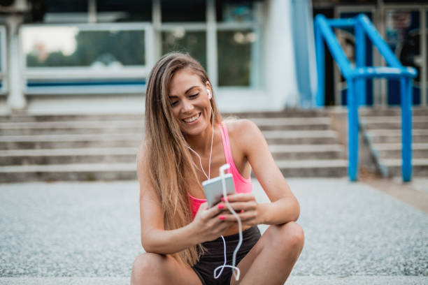 istock Young woman taking a break and using her smartphone 1018502892