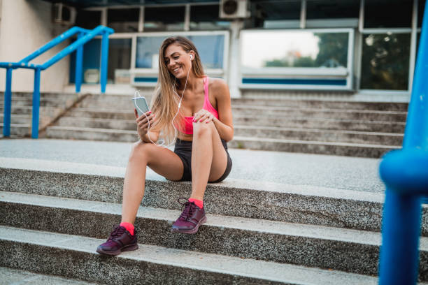 istock Young woman taking a break and using her smartphone 1018503016