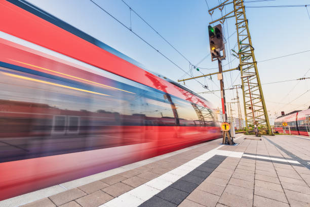 istock High speed train in motion on the railway station at sunset. Red blurred modern intercity train on the railway platform in Europe. Passenger railway transportation. Railroad in the evening. Travel 1018505546