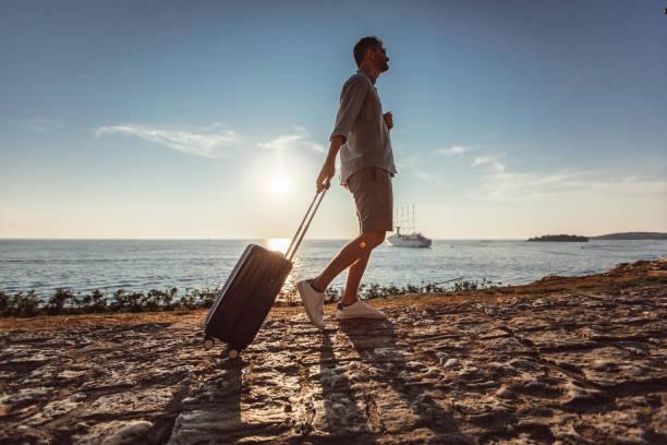 istock Man walking by the sea alone 1018511628