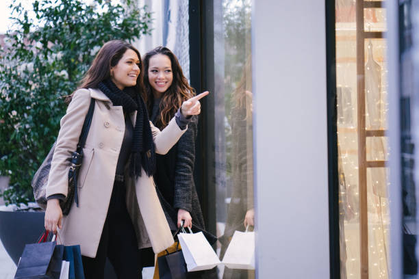 istock Female friends winter shopping 1018511724